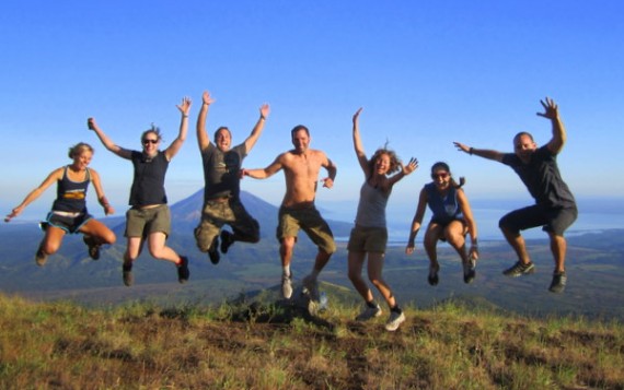 Jumping for joy on top of volcano El Hoyo